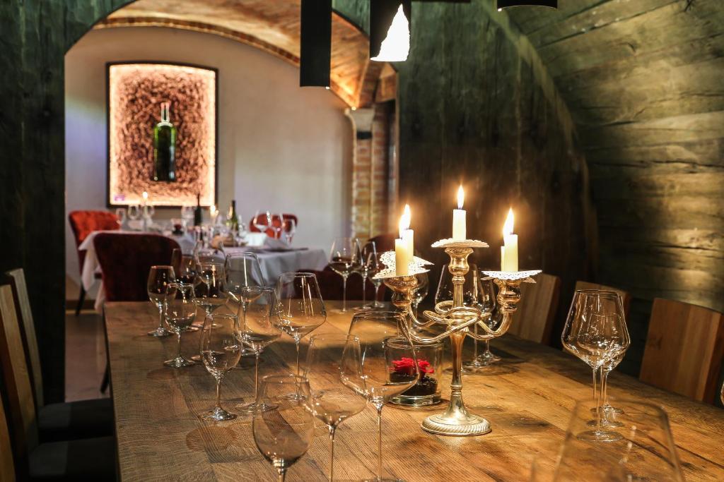 a long table with candles and wine glasses on it at Verwöhnhotel Kristall in Pertisau