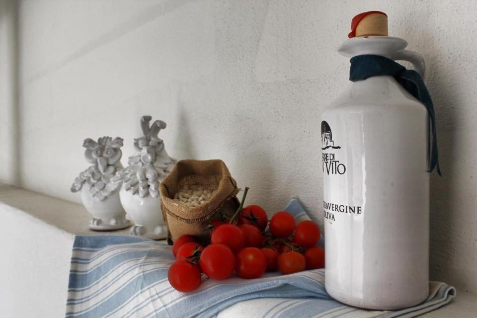 a bottle of milk next to a bunch of tomatoes at La Casetta 19 in Polignano a Mare