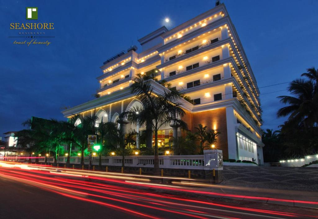 a large white building with a street in front of it at Seashore Residency in Kodungallūr