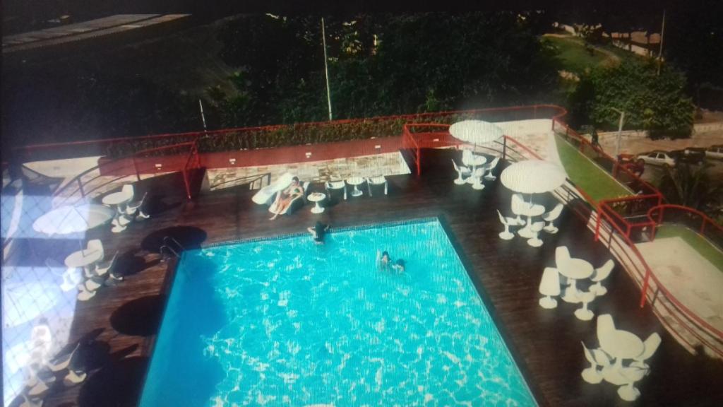 an overhead view of a swimming pool at night at Hotel Victory Business Flat Beira Mar Tambaú in João Pessoa