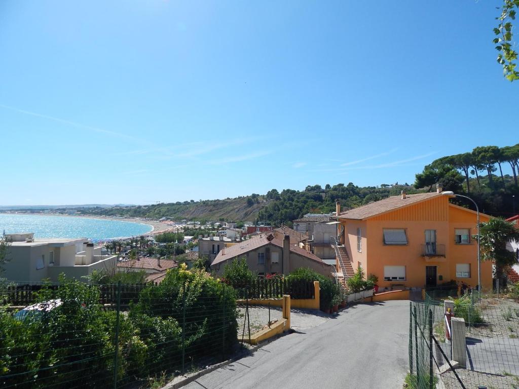 a small town with a beach and a yellow house at Casa Berta, a due passi dal mare in Numana