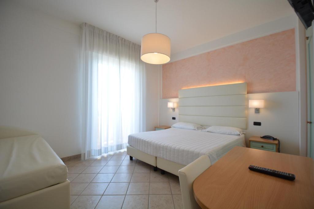 Postel nebo postele na pokoji v ubytování Hotel Palos