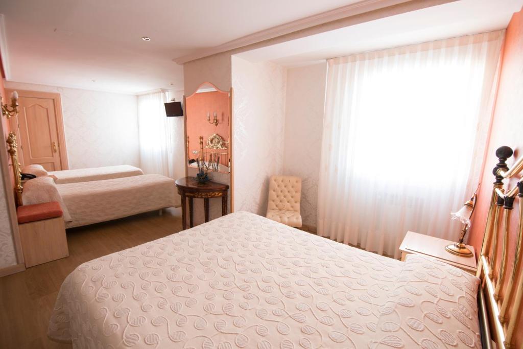 Postel nebo postele na pokoji v ubytování Hotel Julia