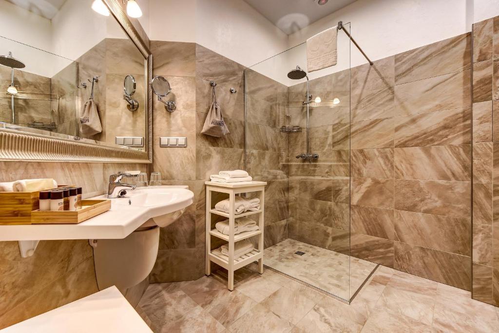 a bathroom with a sink and a shower at Pushka INN hotel in Saint Petersburg
