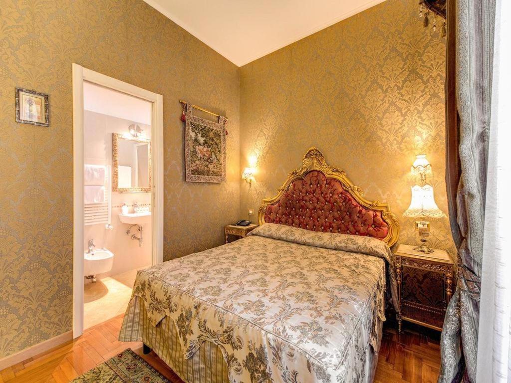a bedroom with a bed and a bathroom at DCBoutiqueHotel in Rome