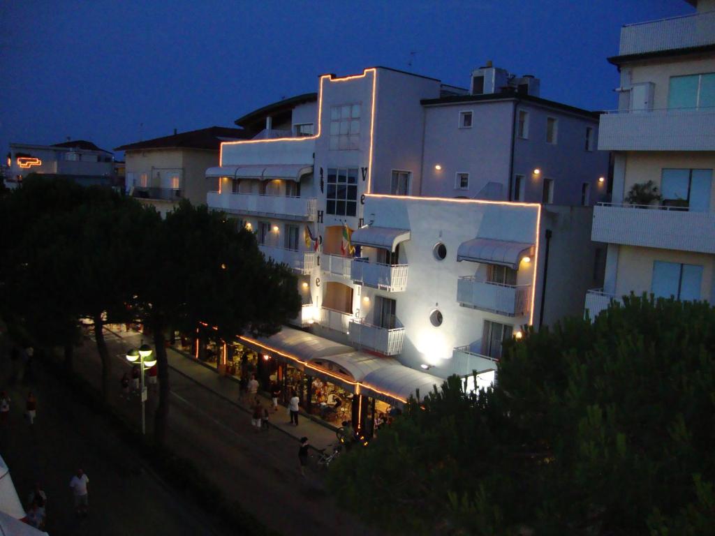 a building with a restaurant in front of it at night at Hotel Venezia in Caorle
