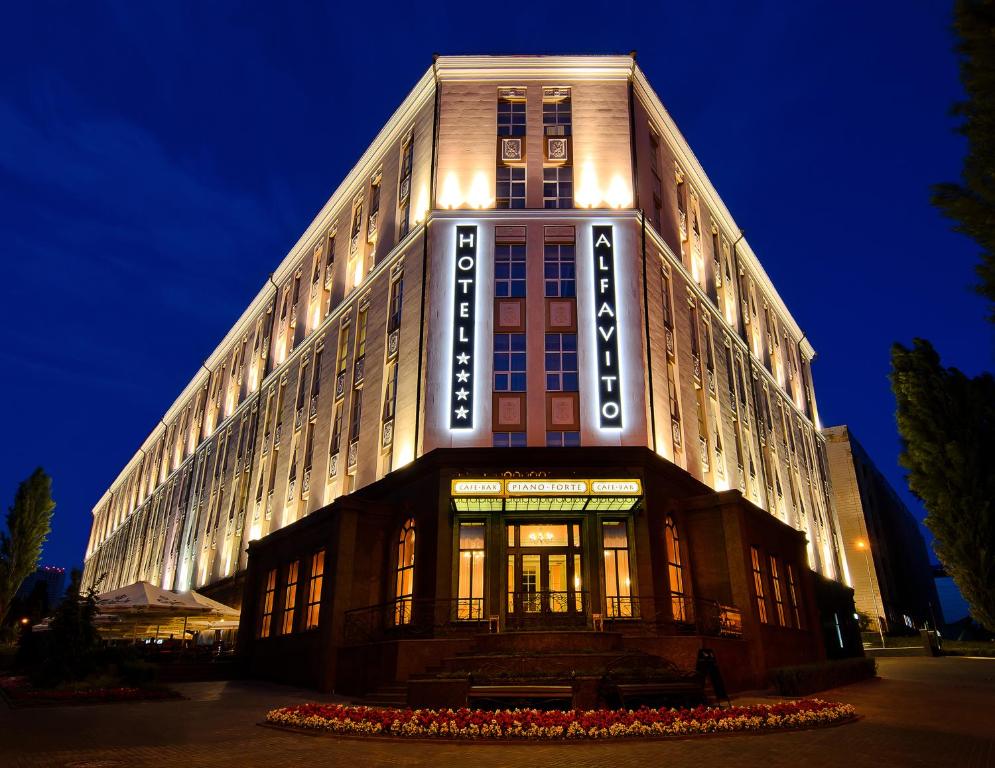 a large building with a sign on the side of it at ALFAVITO Kyiv Hotel in Kyiv