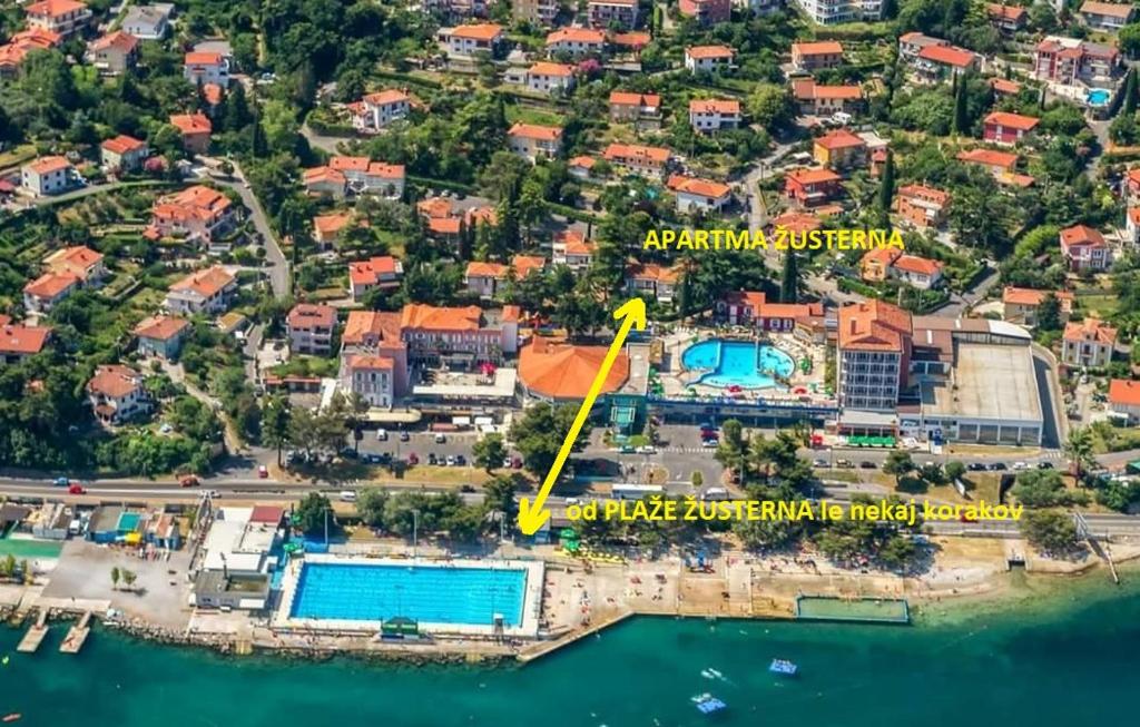 an aerial view of a resort with a yellow arrow pointing to a pool at Apartma Žusterna in Koper