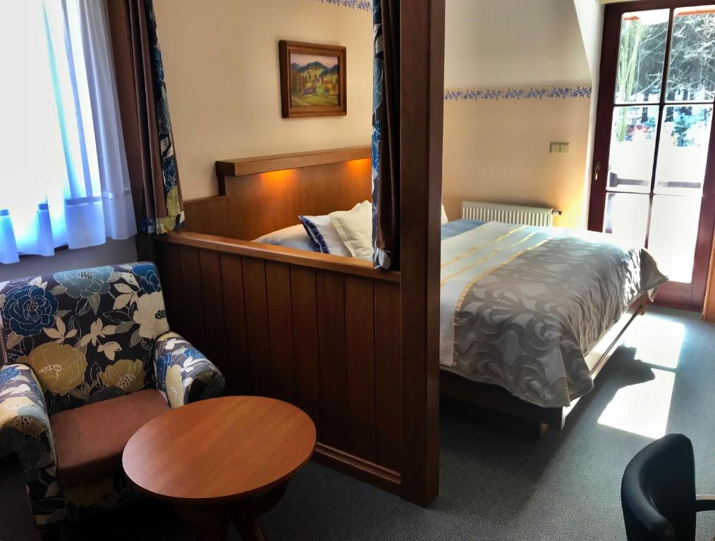 Postel nebo postele na pokoji v ubytování Hotel Na Dolině