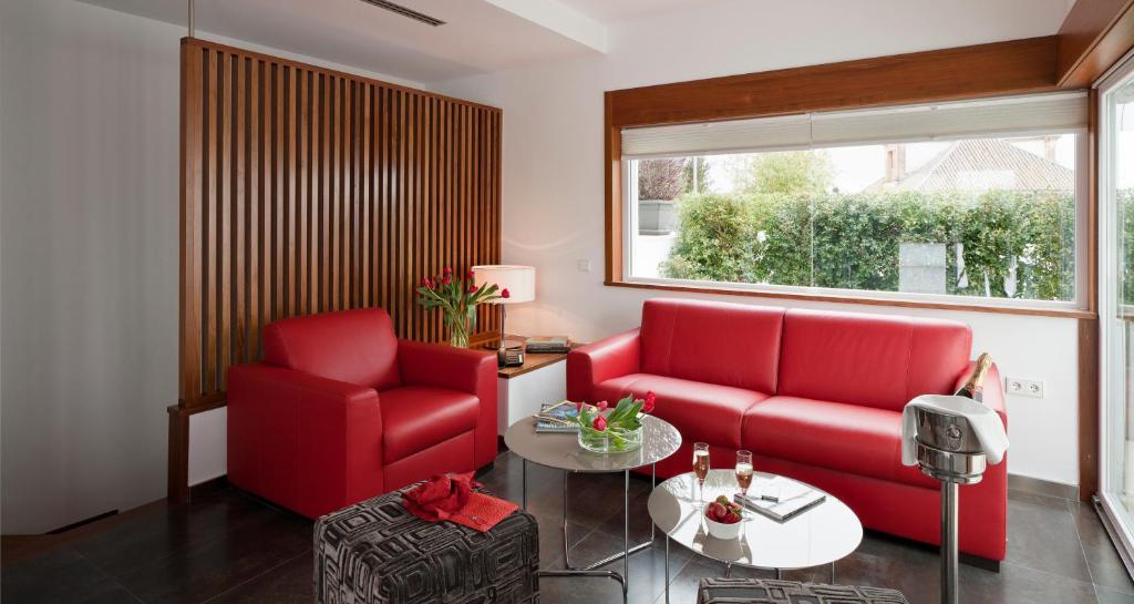 a living room filled with furniture and a window at Apartamentos Eslava in Seville