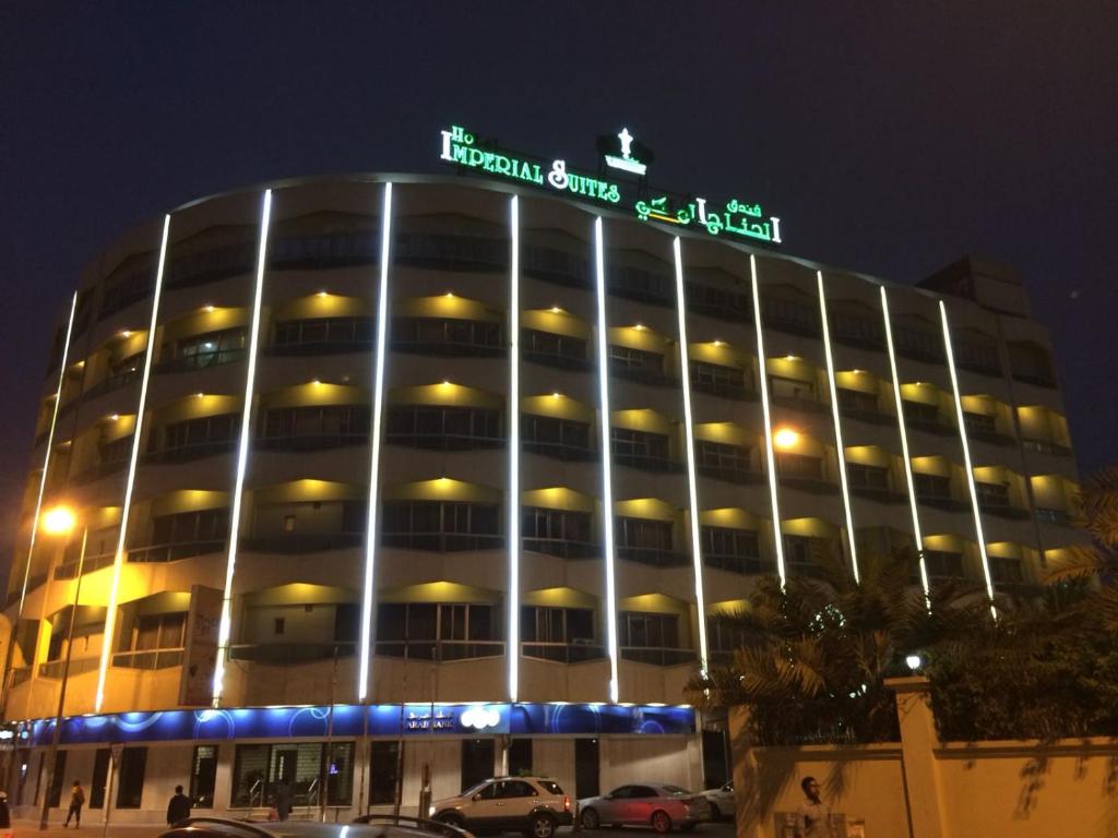 a large building with a sign on top of it at Imperial Suites Hotel in Manama