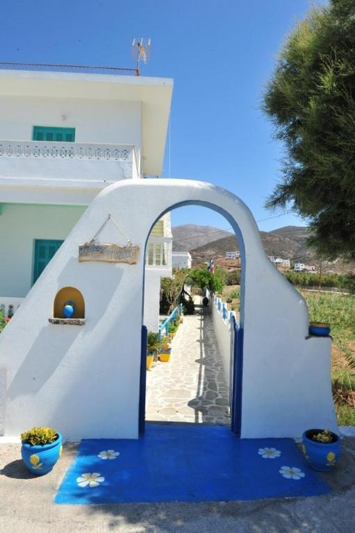 a blue and white stairway leading up to a building at Pension Titika in Katapola