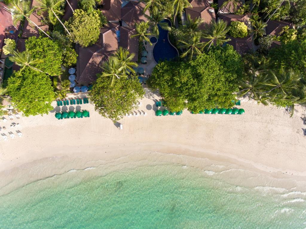 an aerial view of a beach with chairs and the ocean at Baan Chaweng Beach Resort & Spa - SHA Extra Plus in Chaweng