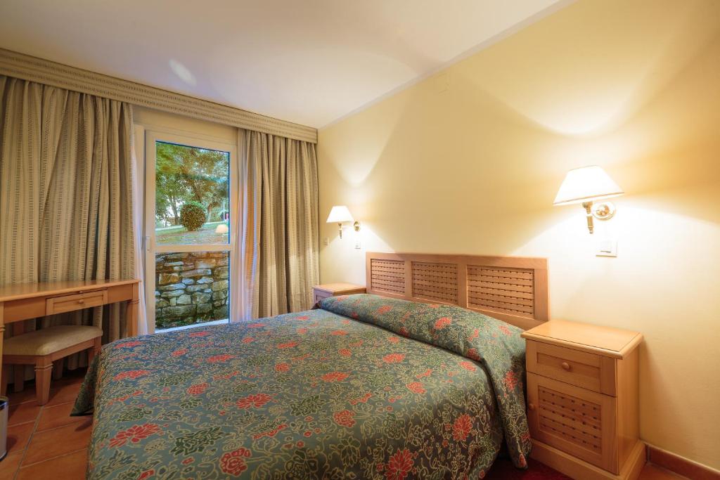 a hotel room with a bed and a window at Apartments Bellevue Plava Laguna in Poreč