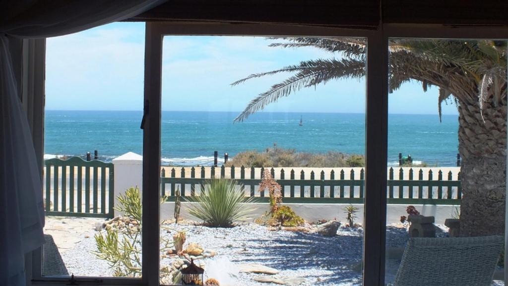 a view of the beach from a house window at The Beachhouse in Port Nolloth