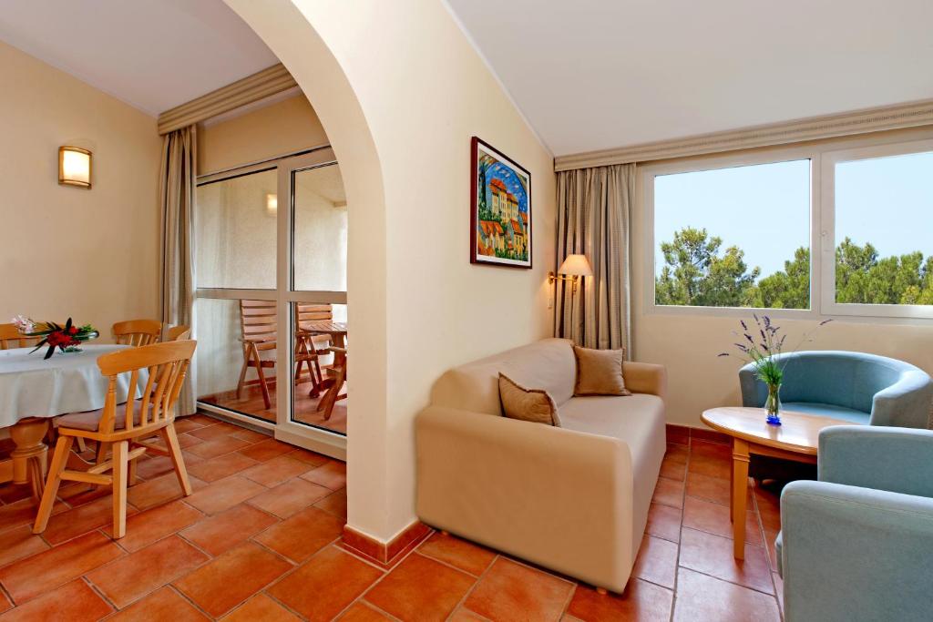 a living room with a couch and a table at Apartments Bellevue Plava Laguna in Poreč