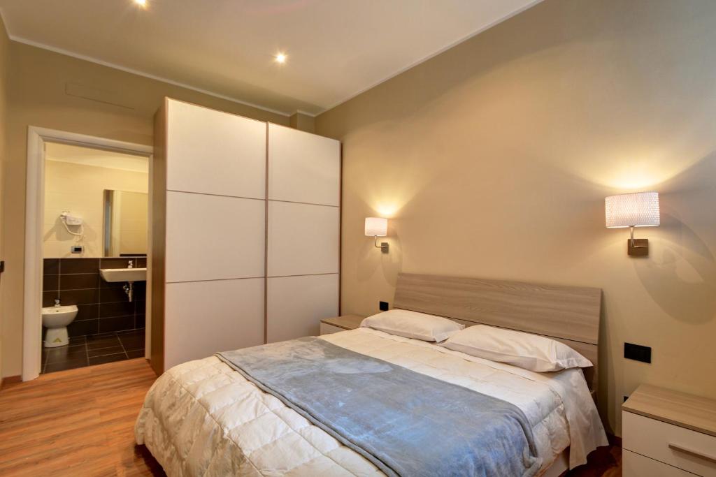 a bedroom with a large bed and a bathroom at Matteotti25 in Turin