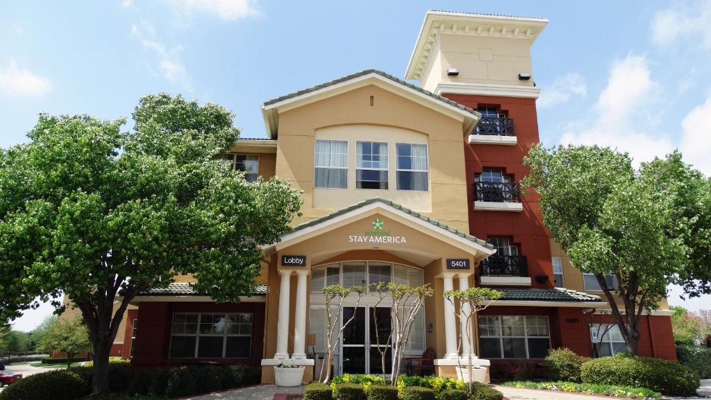 a building with trees in front of it at Extended Stay America Suites - Dallas - Las Colinas - Green Park Dr in Irving
