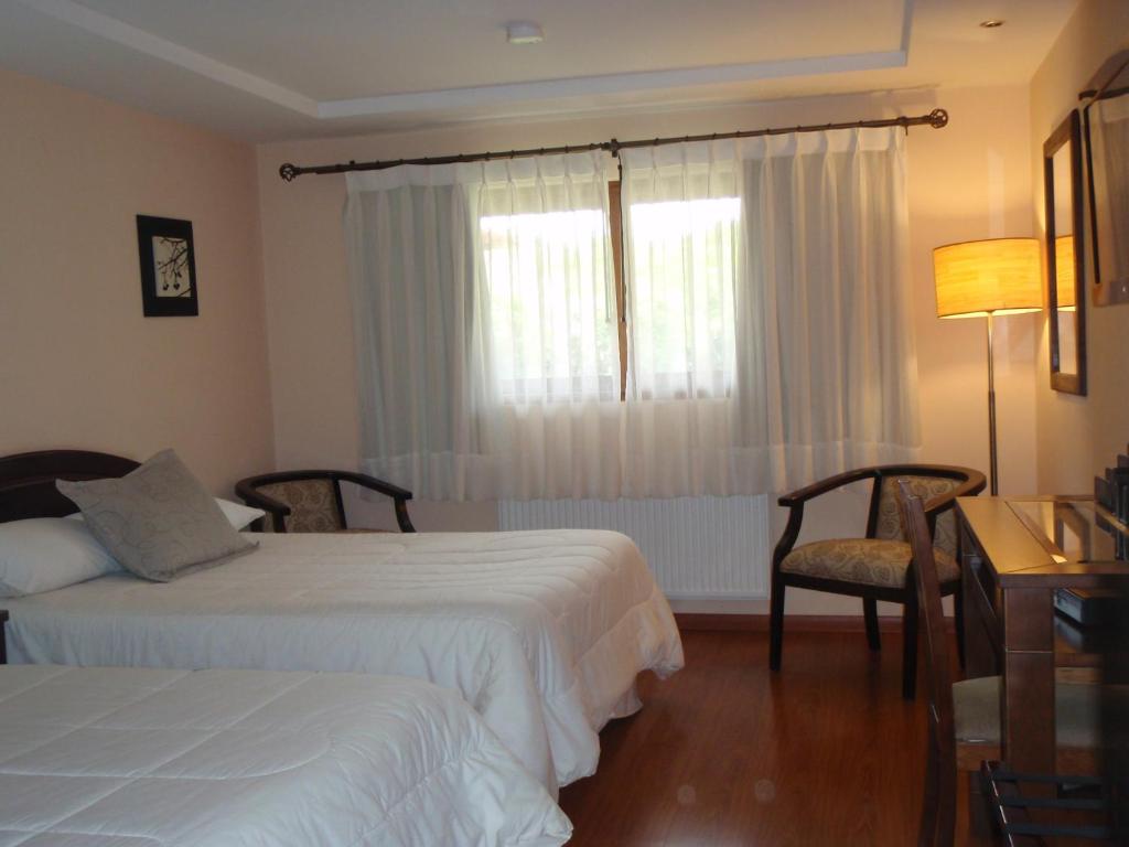 Postel nebo postele na pokoji v ubytování Howard Johnson Hotel Rinconada de Los Andes