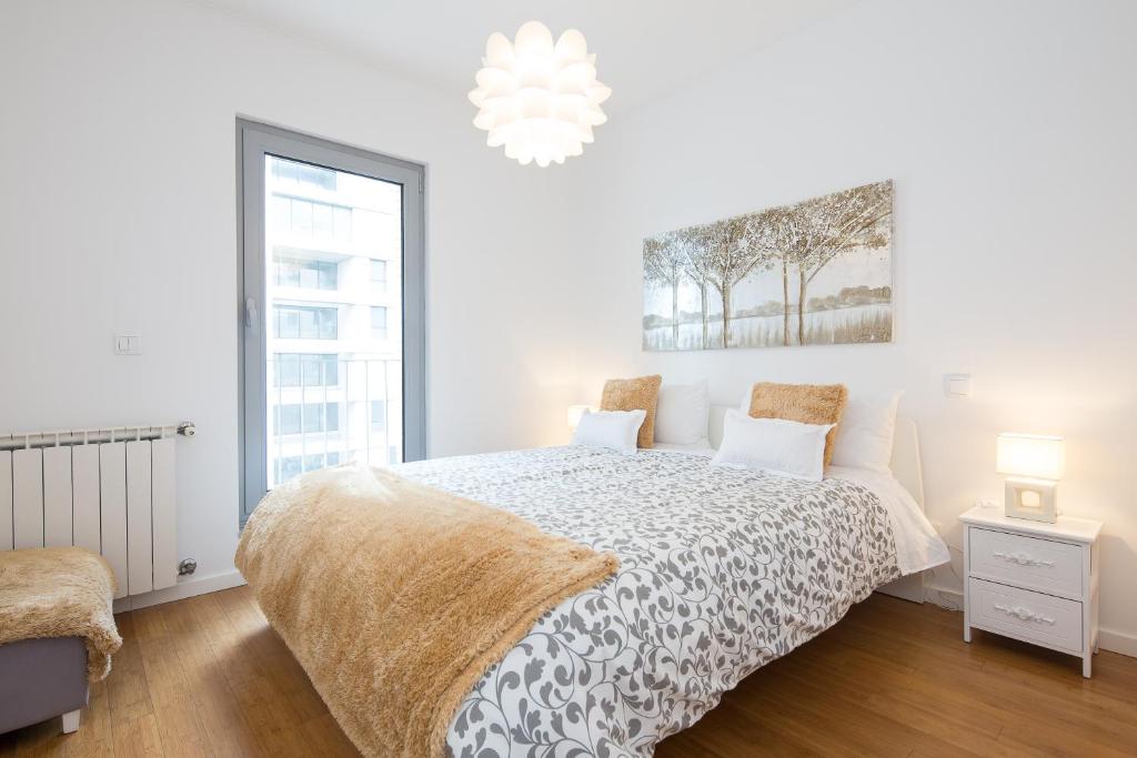 מיטה או מיטות בחדר ב-Lisbon Expo Apartment