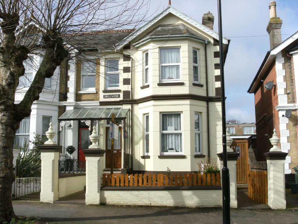 una casa bianca con una recinzione di fronte di Inglewood Guest House a Sandown