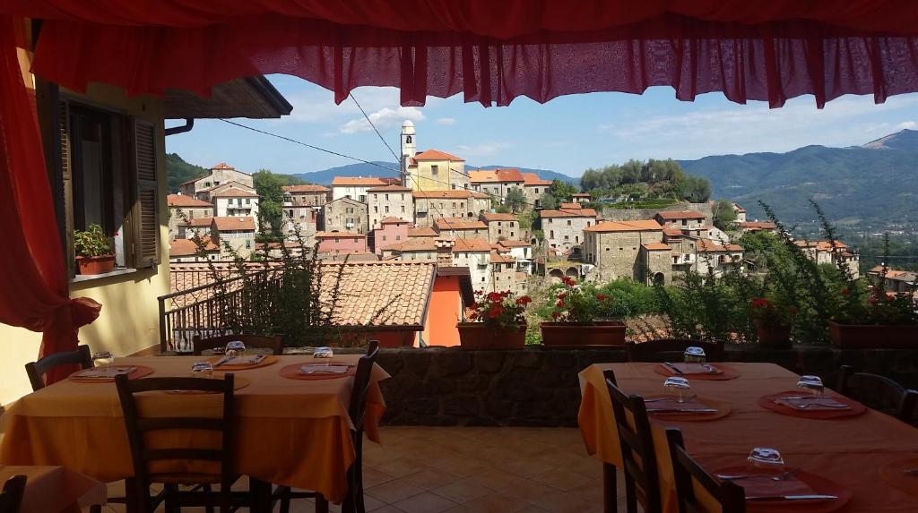 a restaurant with two tables and a view of a city at Hotel Ristorante El Caracol in Mulazzo