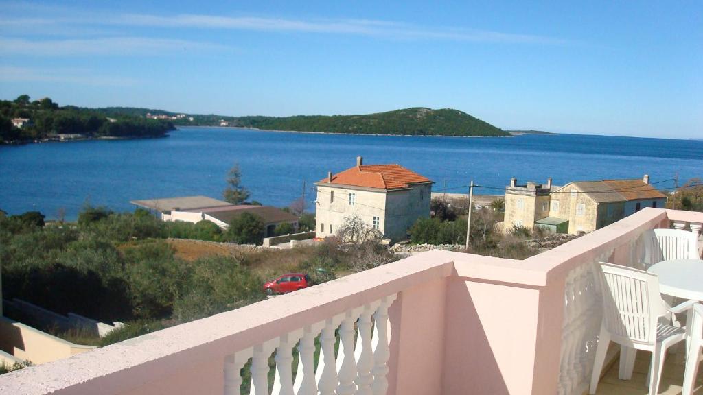 a balcony with a view of a body of water at Guesthouse Villa Ljubica in Soline