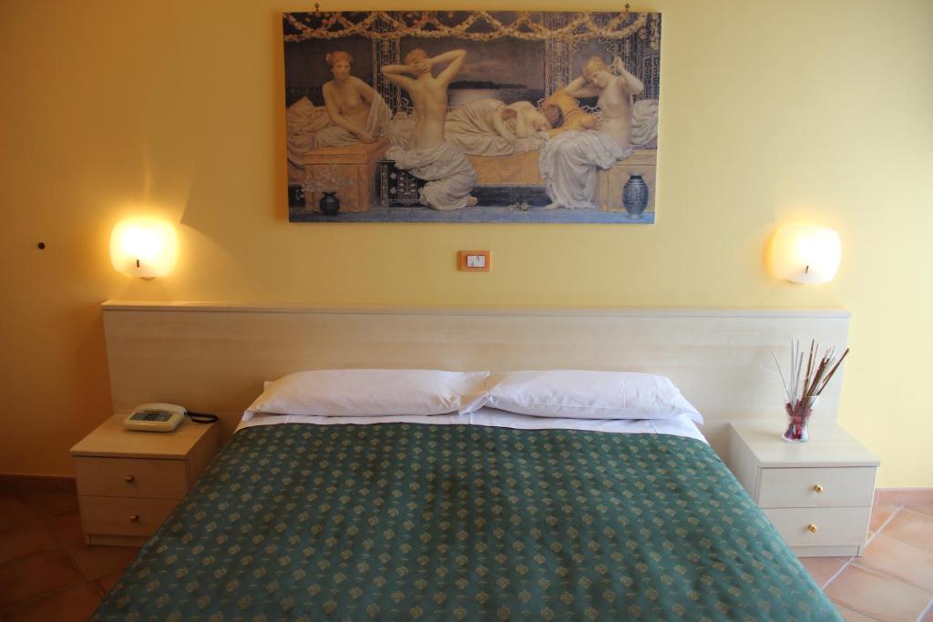 Łóżko lub łóżka w pokoju w obiekcie Hotel Di Rocco
