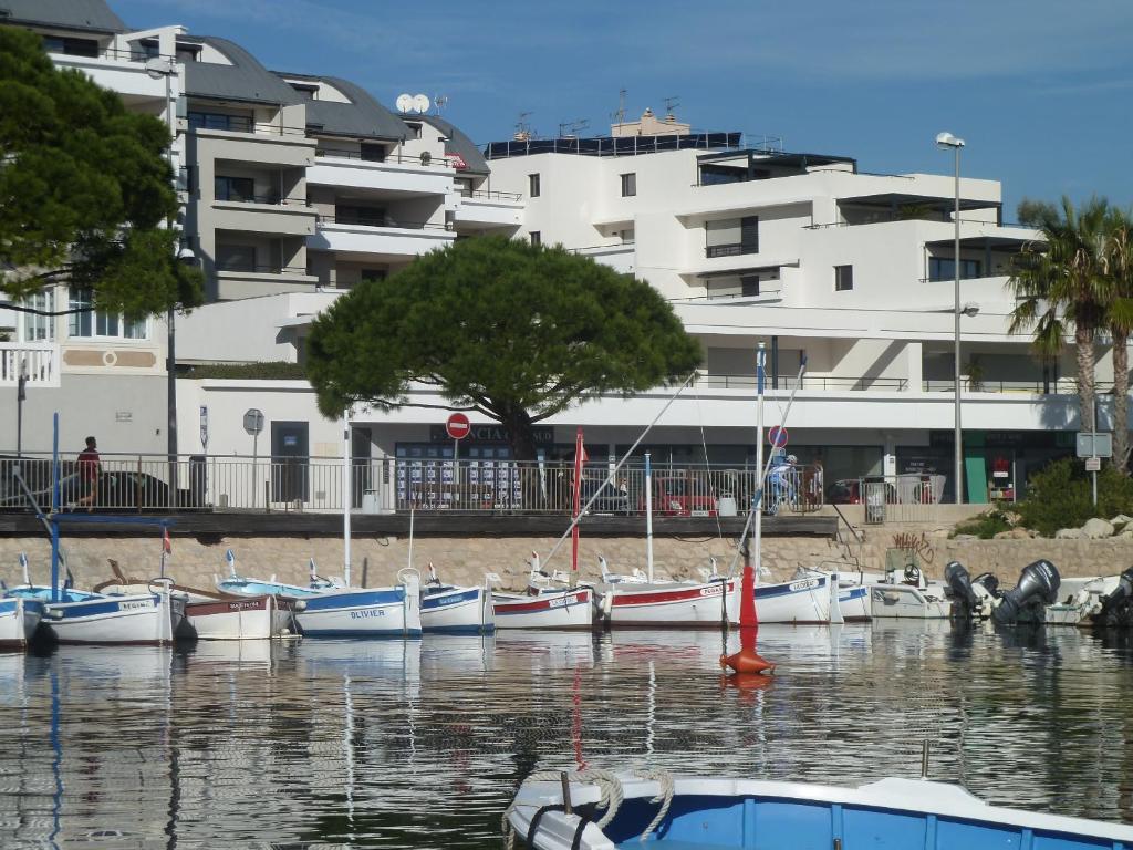 a group of boats in the water in front of a building at O de mer D101 in La Ciotat