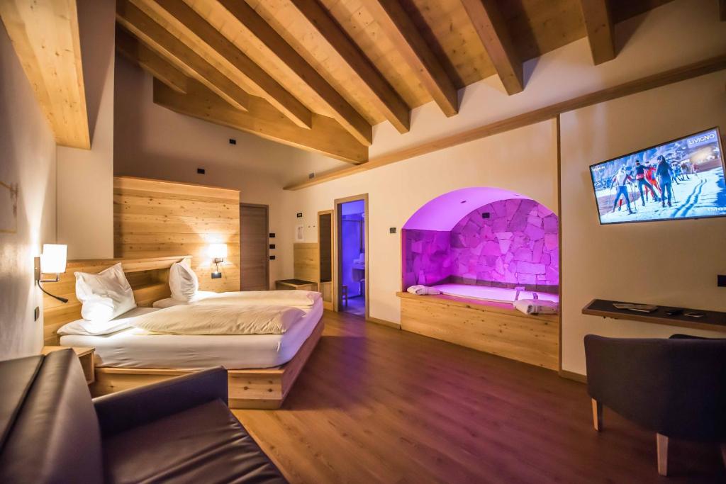 Postel nebo postele na pokoji v ubytování Hotel Le Alpi