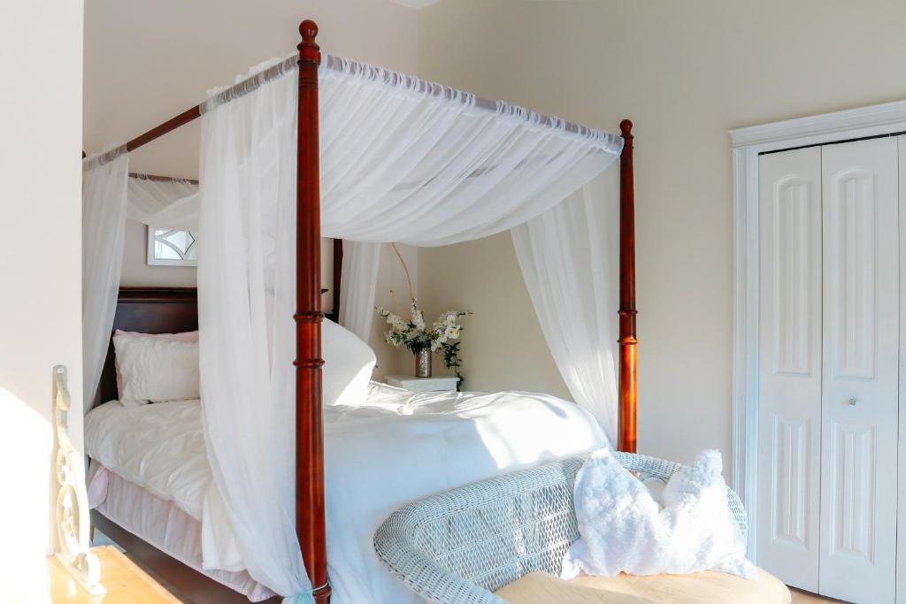 a bedroom with a four poster bed with a canopy at Star of the Sea B&B in Halifax