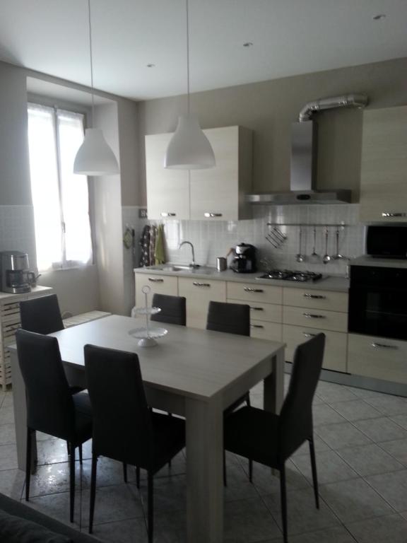a kitchen with a table and chairs in a kitchen at Casa Bruna in Verbania
