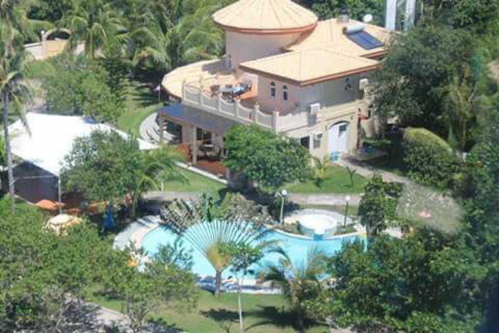 an aerial view of a house with a swimming pool at Cabilao Sunset Dive & Beach Resort in Loon