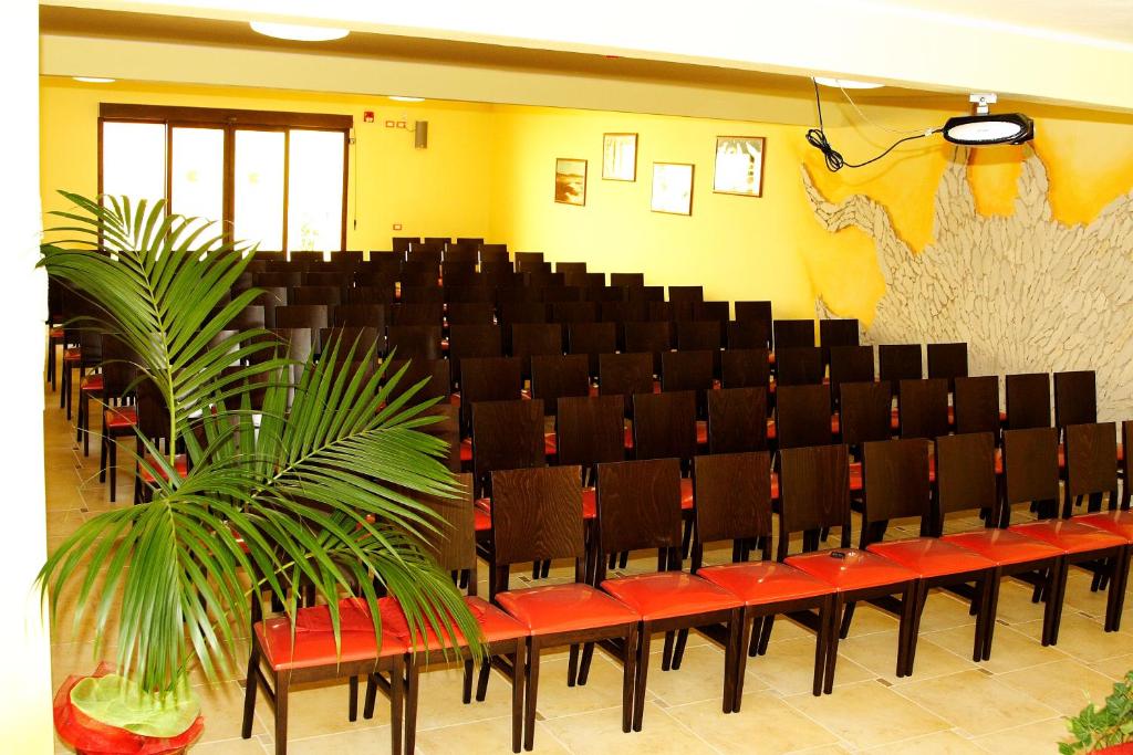 a row of chairs with red seats in a room at Su Soi in Càbras