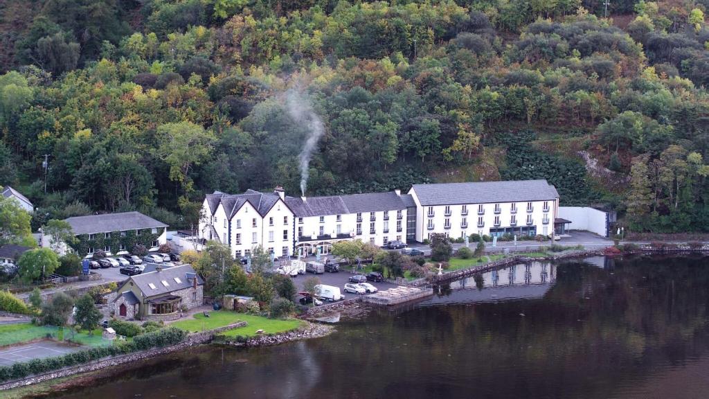 an aerial view of a building next to a body of water at Leenane Hotel in Leenaun