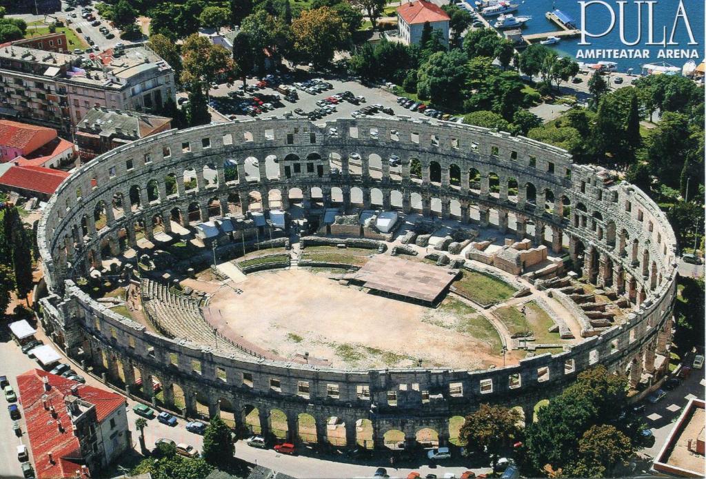 ein großes Amphitheater in einer Stadt mit einem Gebäude in der Unterkunft Apartment Mario in Pula
