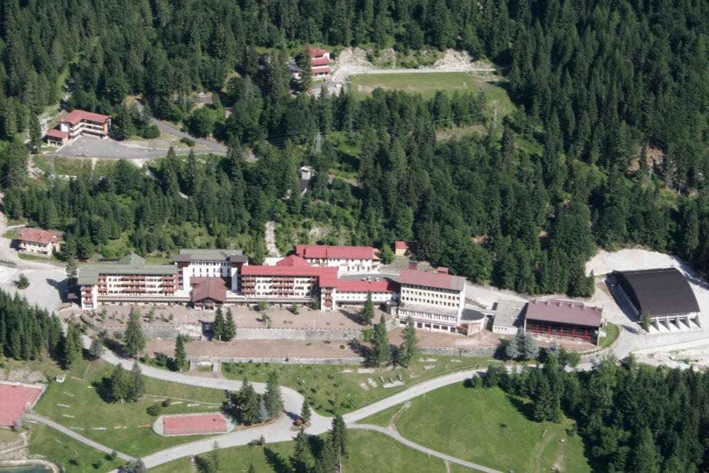an aerial view of a building in the middle of a forest at Bella Italia & EFA Village in Forni Avoltri