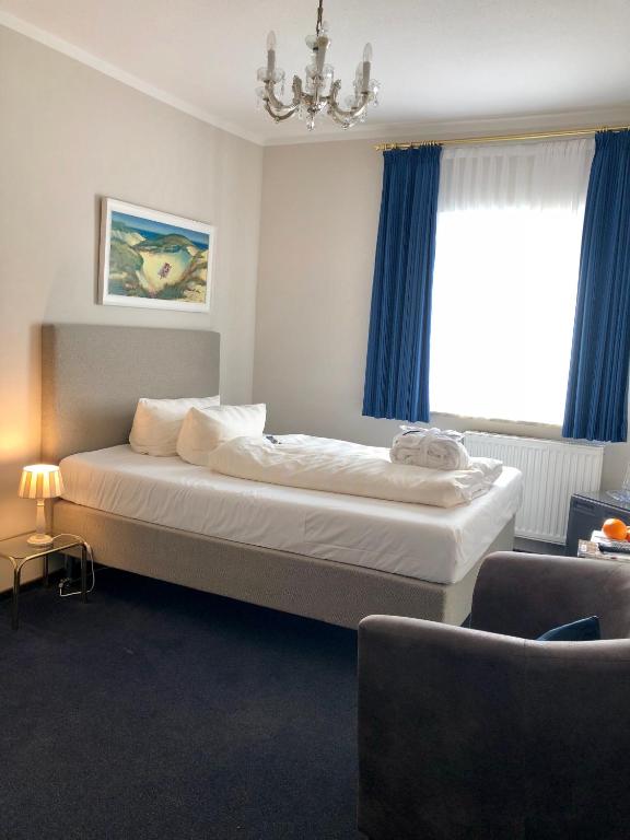 Postel nebo postele na pokoji v ubytování Hotel Sylter Blaumuschel