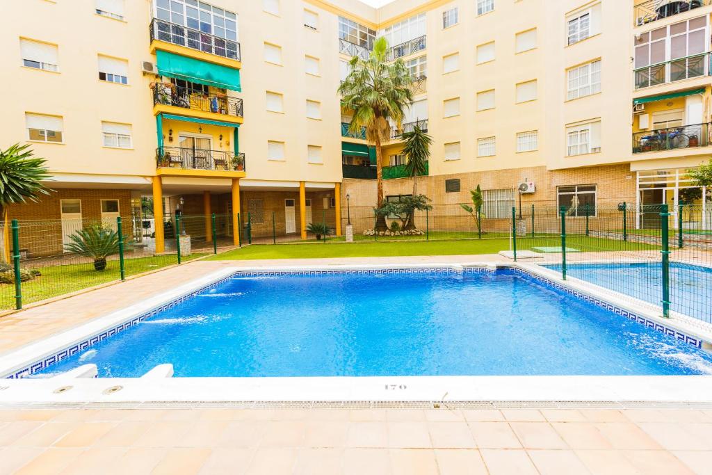 a swimming pool in front of a building at Pisoelpuerto in El Puerto de Santa María