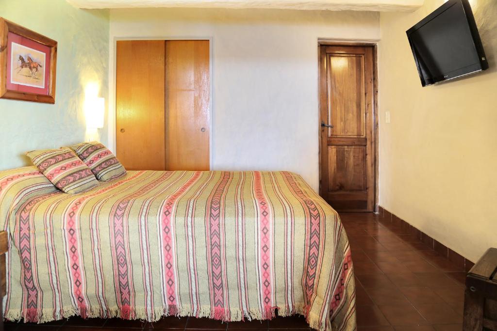 Postel nebo postele na pokoji v ubytování La Caleta Bungalows