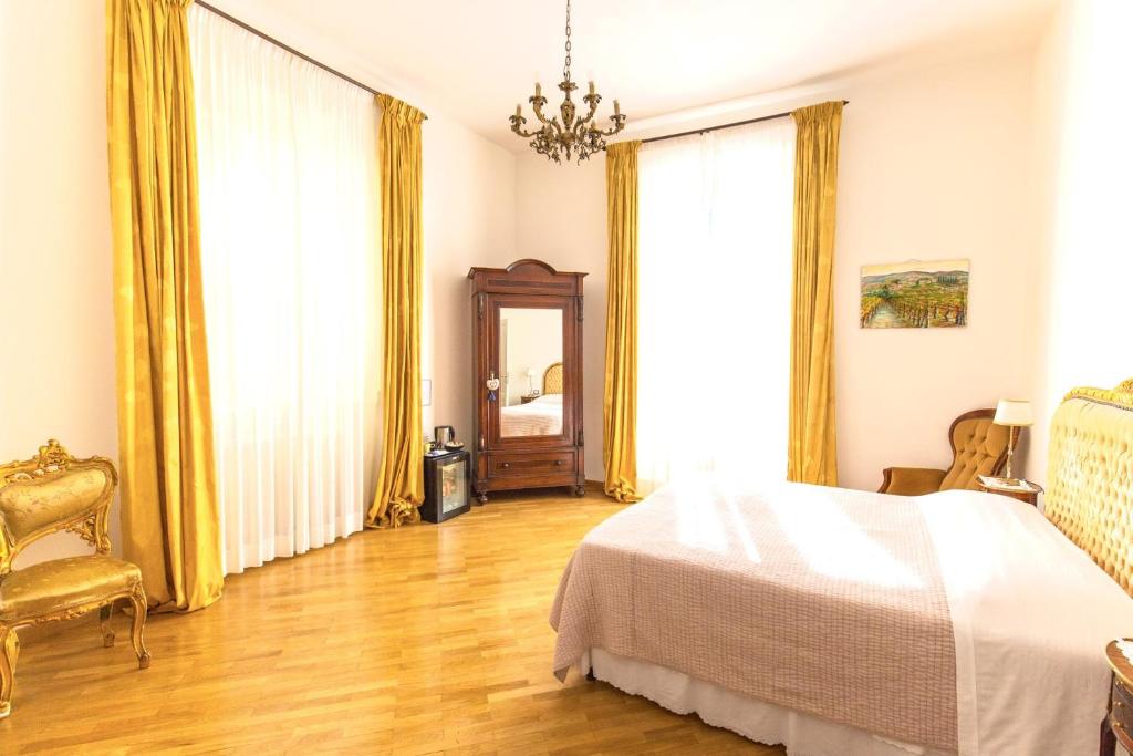 a bedroom with a bed and a large window at Gourmet B&B Villa Landucci in Florence