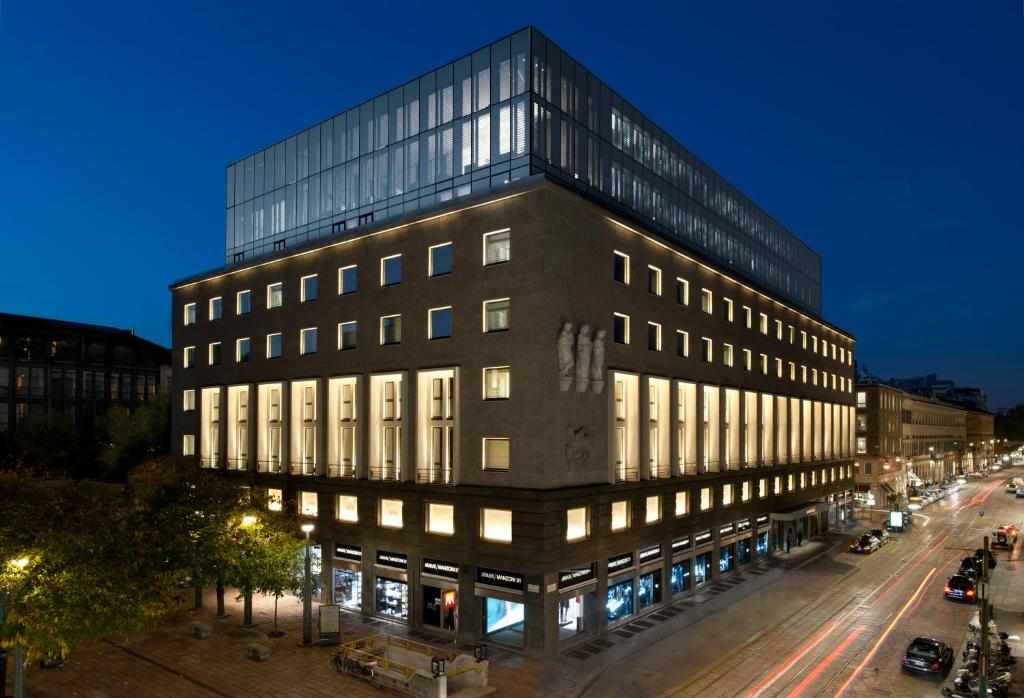 a building on a street at night at Armani Hotel Milano in Milan