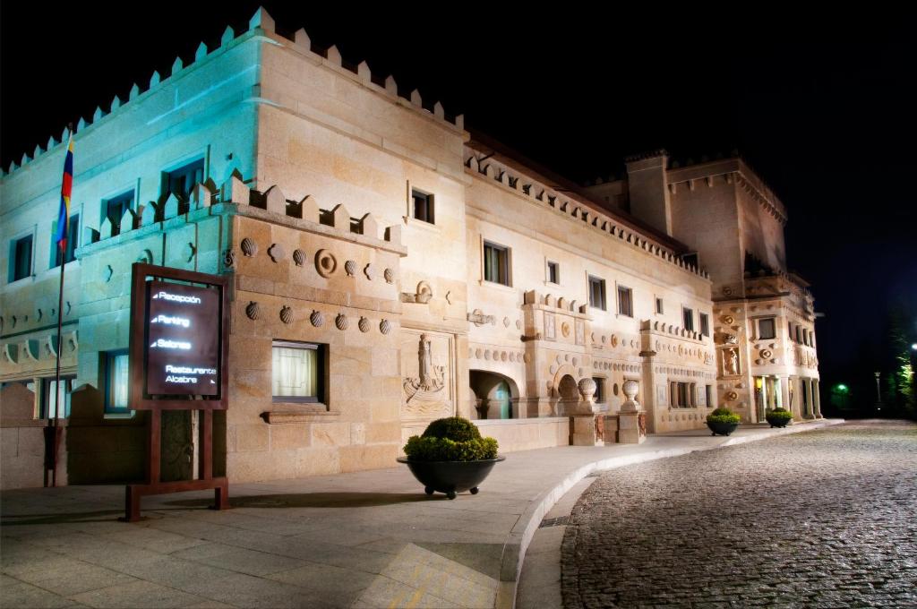 un edificio con un cartel delante de él por la noche en Pazo Los Escudos Hotel Spa & Resort, en Vigo