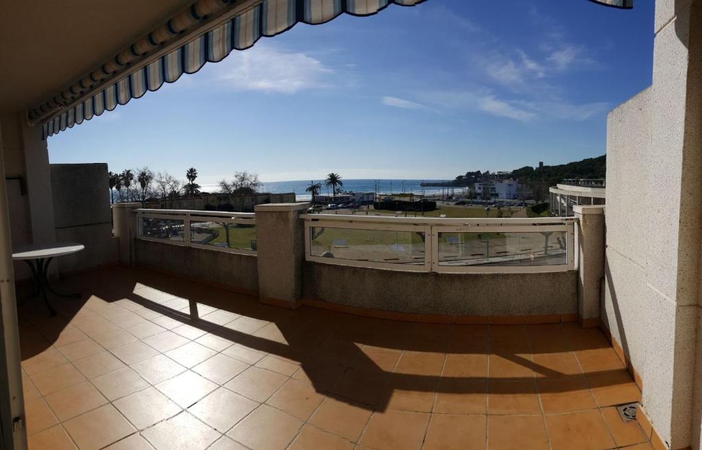 a balcony with a view of the ocean at Cala Azul 304-306 Tamarit in Tamarit