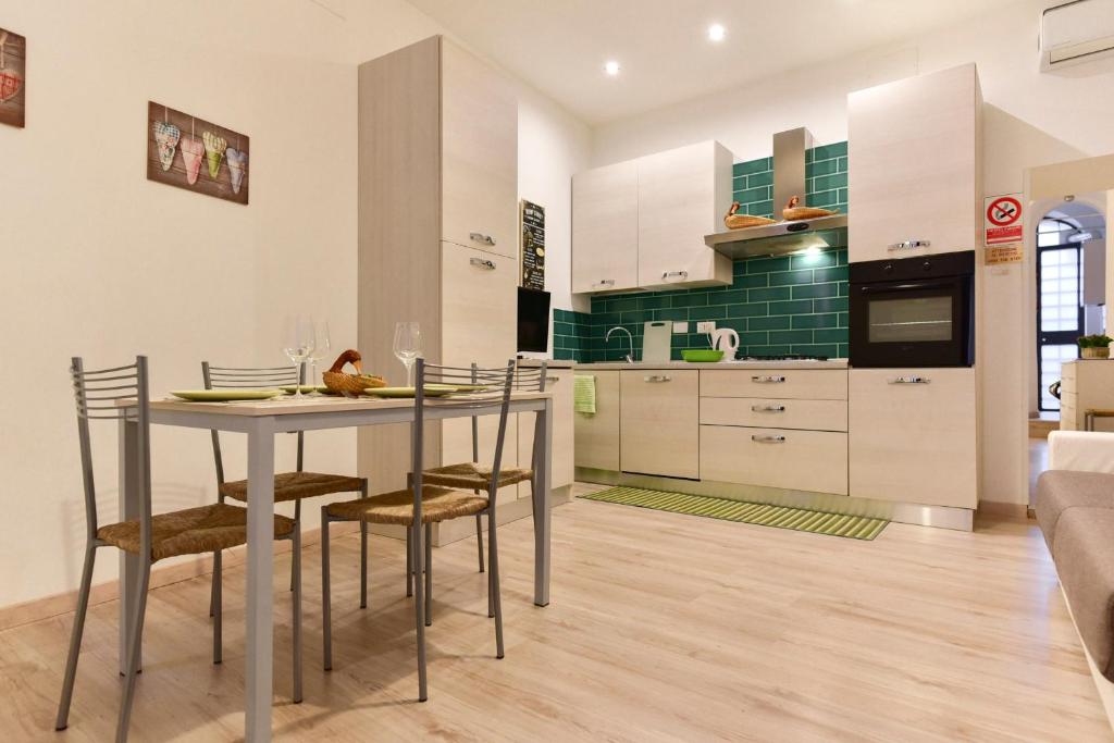 a kitchen and dining room with a table and chairs at BMGA l Coliseum Rome Apartment 1Bdr for Couples in Rome