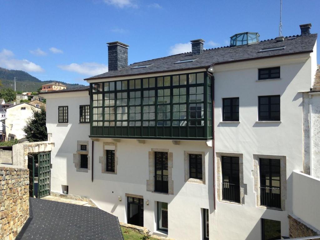 un edificio blanco con ventanas negras encima en Casa Pedrosa, en Mondoñedo