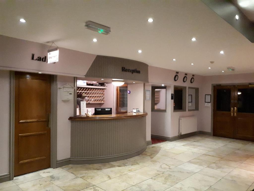 a waiting room with a bar in a restaurant at The Highfield Hotel in Bradford