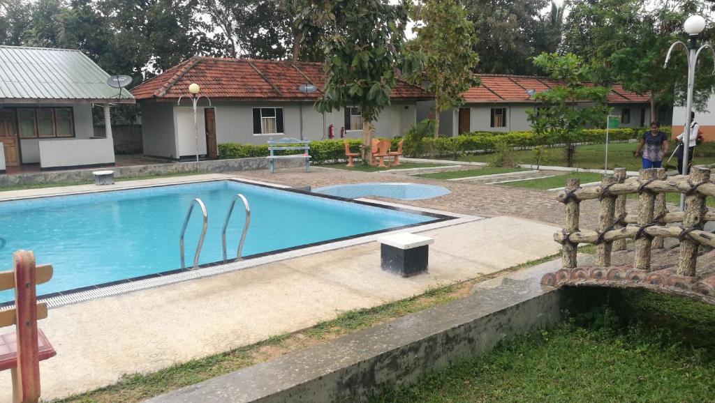 a swimming pool in front of a house at Friends Paradise in Kilinochchi