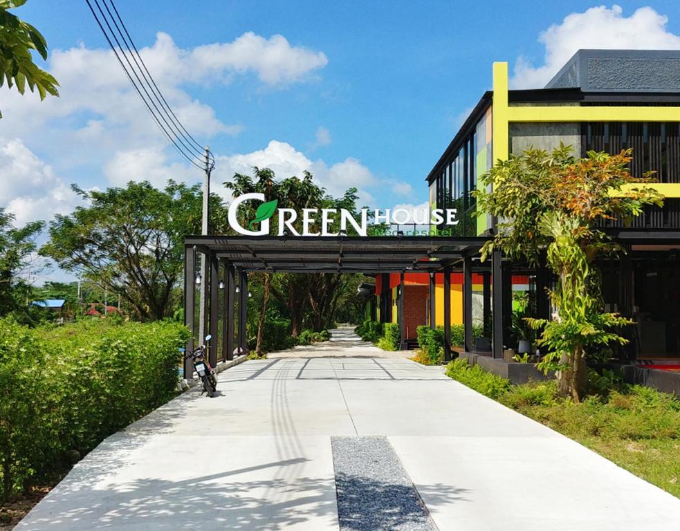 a sign over a walkway in front of a building at GREEN HOUSE Neo-Resotel in Nakhon Si Thammarat