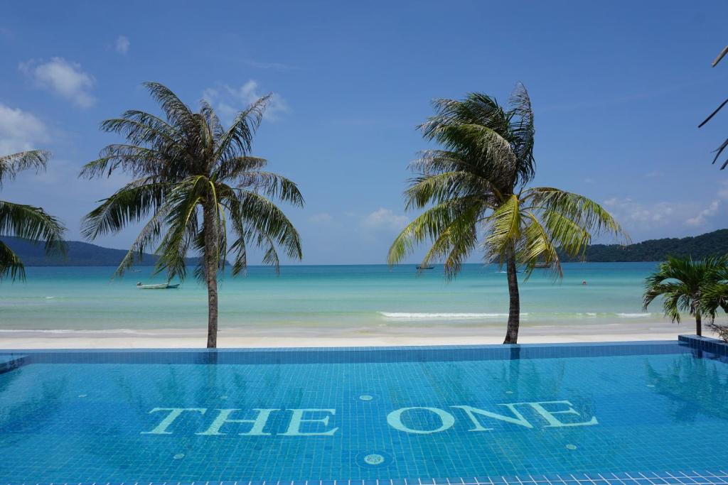 a beach with palm trees and palm trees at The One Resort in Koh Rong Sanloem